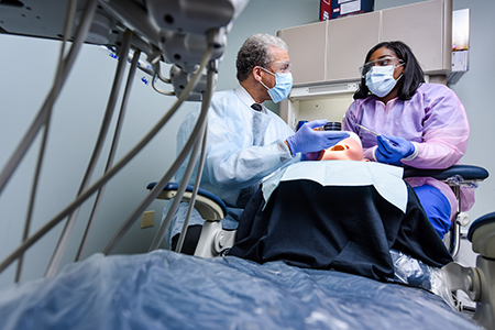 Remington College Students receive guidance from Instructors in the Dental Assisting Program